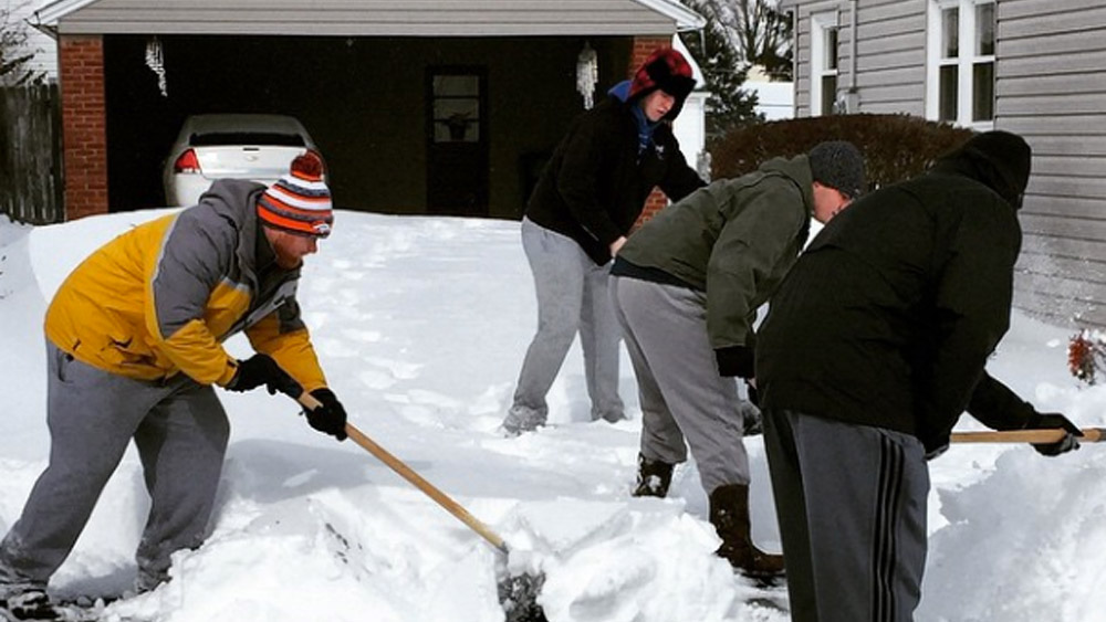 Centre players shoveling snow for a neighbor in Danville.