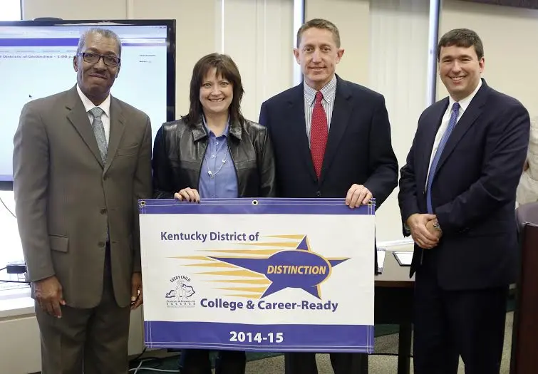 The Fort Thomas Independent school district was recognized as a District of Distinction for the 2014-15 school year by the Kentucky Board of Education at its February meeting. Pictured at the presentation of the District of Distinction banner are, left to right, William Twyman, KBE vice chairman; Karen Allen, Fort Thomas Independent Board of Education chairwoman; Gene Kirchner, Fort Thomas Independent superintendent; and Stephen Pruitt, Kentucky education commissioner (provided photo)