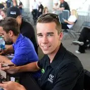 Rhodes signing autographs for fans before a race.