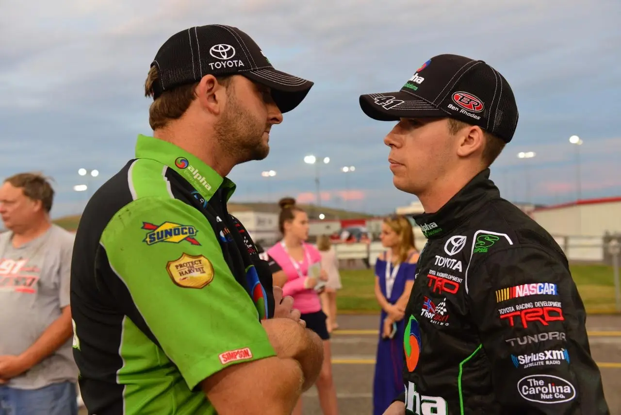 Rhodes discusses strategy with a member of his team prior to a race earlier this year
