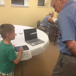 Five-year-old Lucas Meyer demonstrates Footsteps2Brilliance for grandfather Joe Meyer's edification.