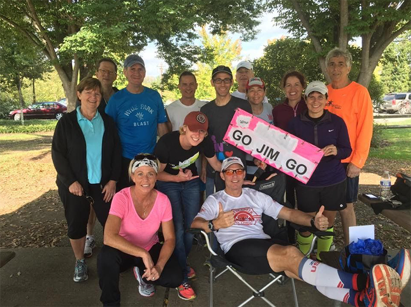 Jim White (sitting) and some of his supporters relax after the Triple Ironman is completed. (Photo provided)