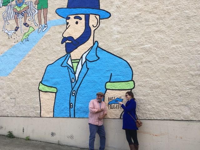 Jarrod BEcker and Leslie Ammon of BLDG in front of one of the mural images. Kroger partnered with BLDG on the project and Becker said he drew his inspiration for the mural from the people of Covington and its history (photos by Mark Hansel)