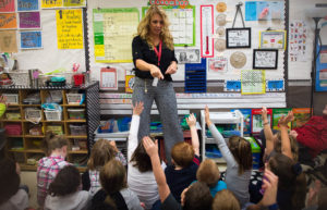 Kim Setty, a second grade teacher at Mary A. Goetz Elementary, counts out the number of students who have green eyes during her class. (Photo by Bobby Ellis)