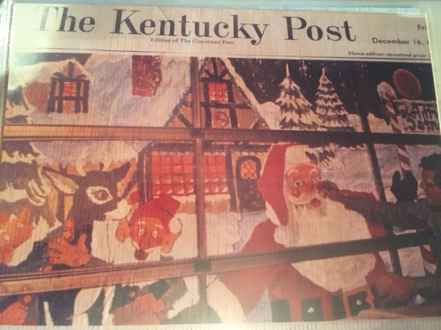 Schmidt keeps a copy of a Kentucky Post story featuring one of his holiday paintings on the doors of Company 8 firehouse.